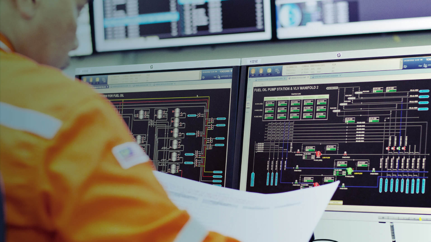 looking over the shoulder of a worker and a dashboard