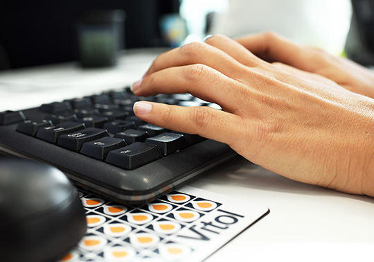 keyboard, hands typing with corporate logo/branding