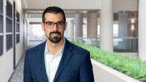 Gentleman in an office face to camera smiling