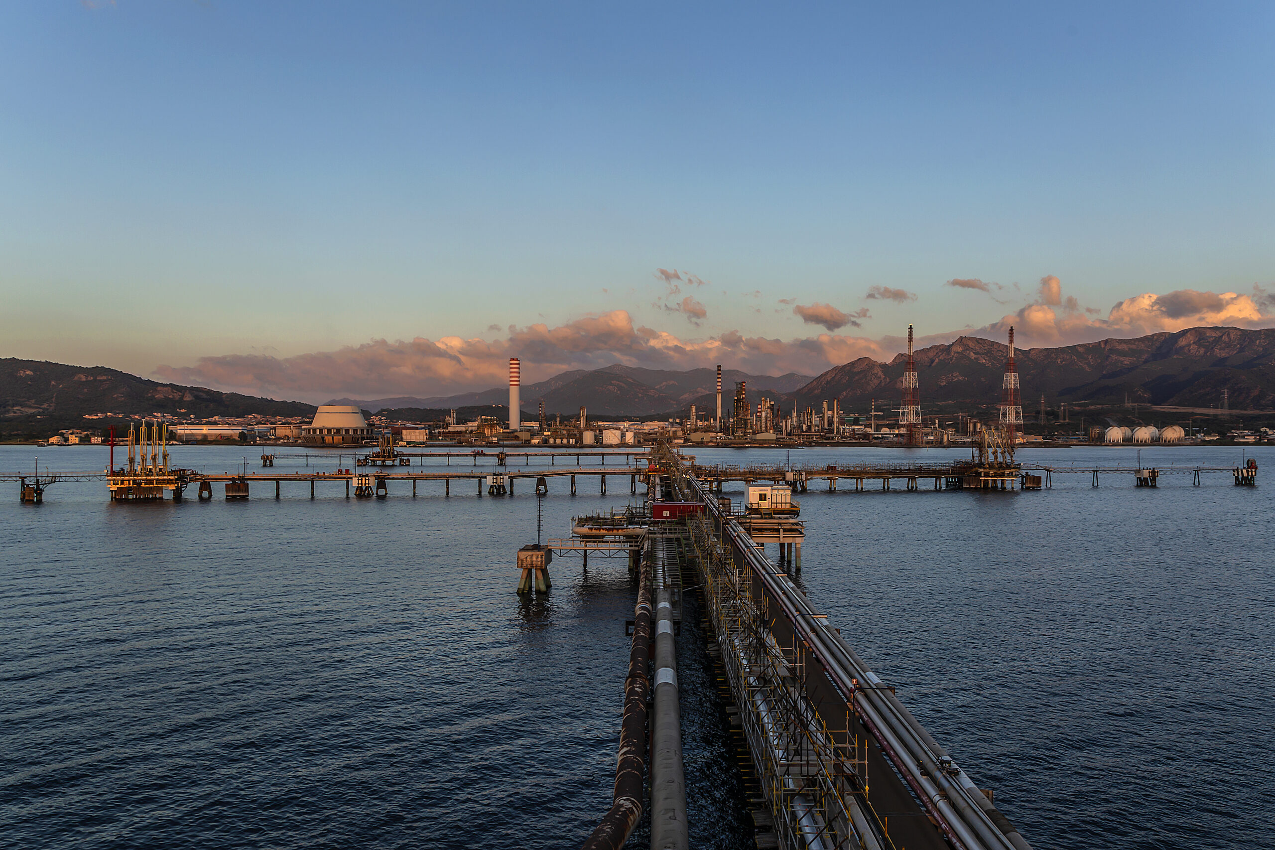 refinery in the distance at dusk