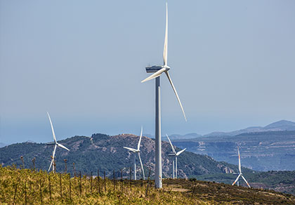 Wind turbines across rolling hills