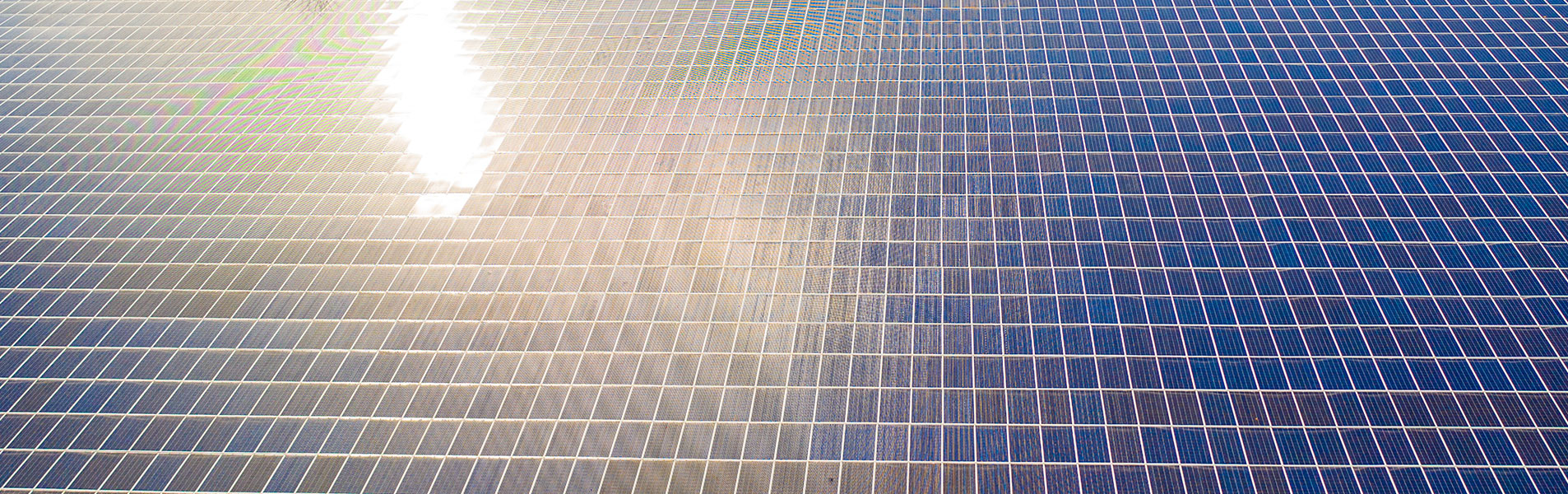 large solar panels with sunshine reflecting from them