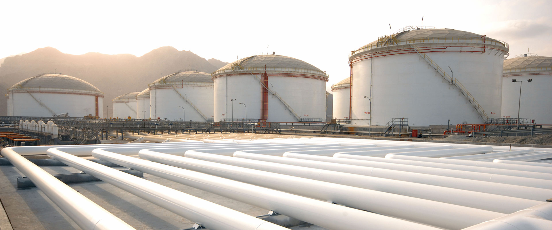 storage tanks and pipes at dusk